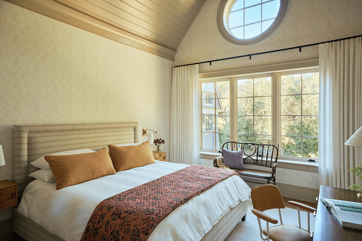 Luxury primary suite with vaulted wood ceiling and refined natural light