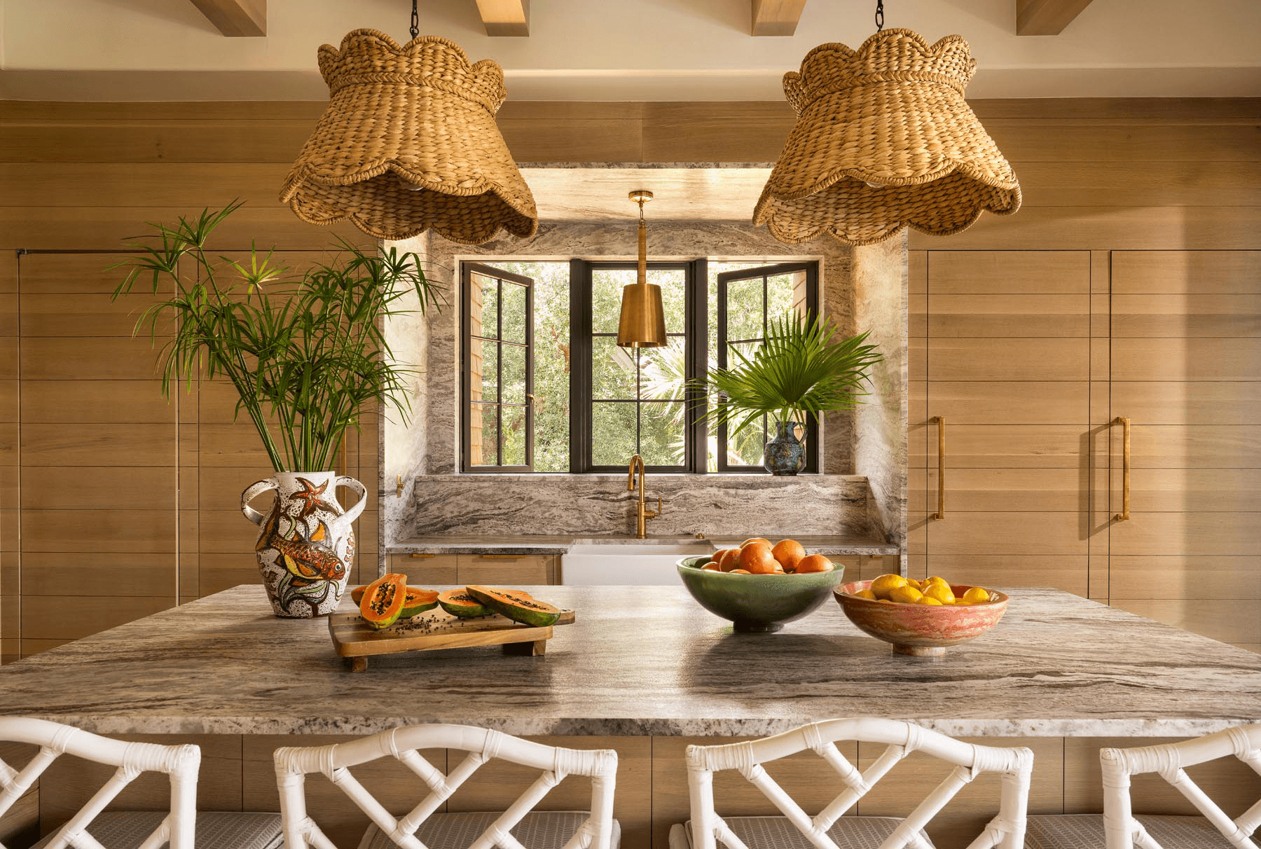 Luxury kitchen with stone backsplash, wood cabinetry, and brass details