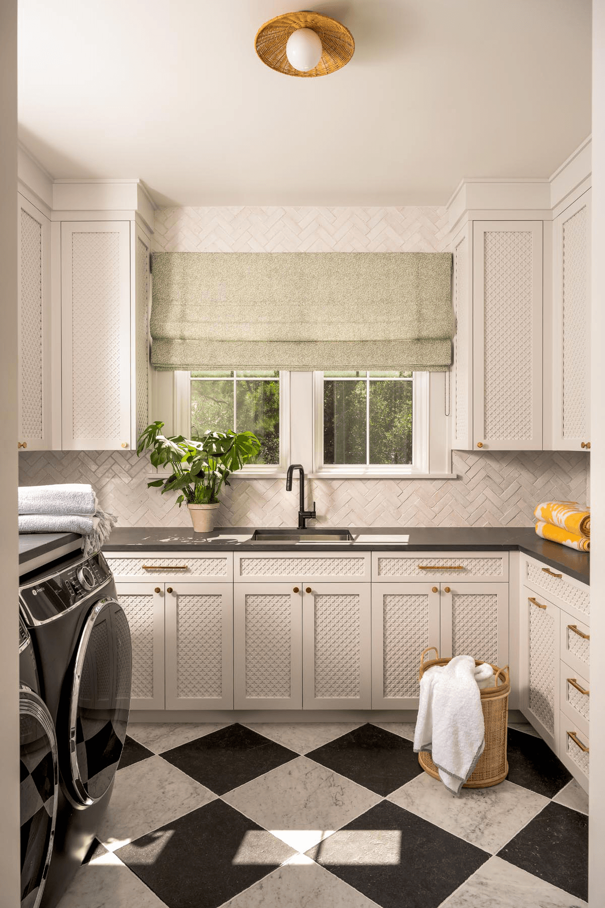 Luxury laundry room with custom cabinetry and refined finishes