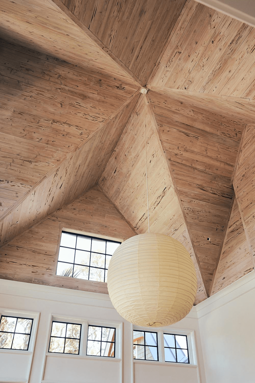 Custom vaulted wood ceiling with refined lighting in a luxury residence